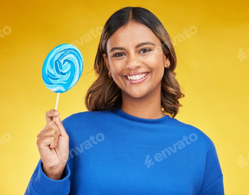 Preview: Happy, candy and portrait of a woman, lollipop and positive girl on a yellow studio background. Fac
