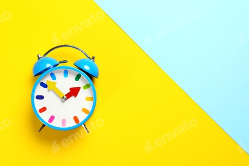 Preview: Top view of alarm clock on colorful background. Space for text