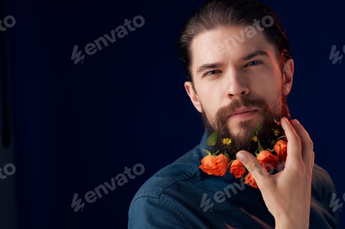 Preview: portrait of a man with flowers in a beard in a black shirt dark background