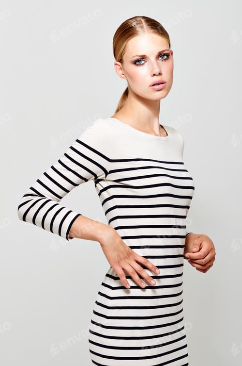 Striking Woman in Striped Dress with Blonde Hair