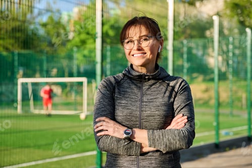 Preview: Outdoor portrait of active smiling middle aged woman looking at camera