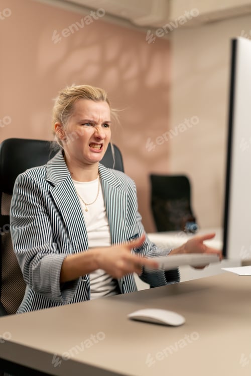 Preview: in a bright office a young blonde employee works at a white monitor on a light table modern office