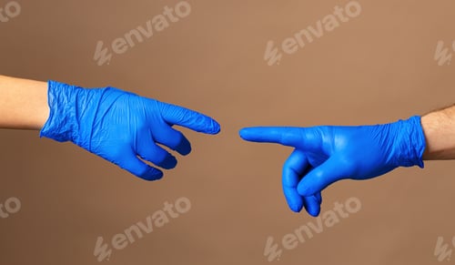 Preview: Male and female hands in medical gloves stretch to each other. Help concept.