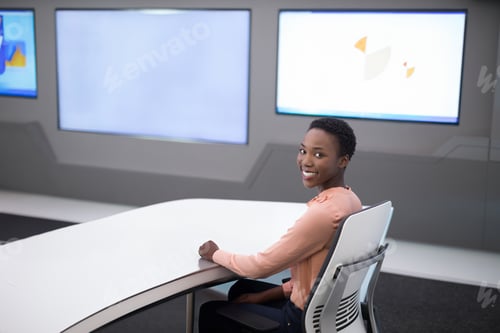 Preview: Smiling woman sitting at modern desk in high-tech office environment, copy space