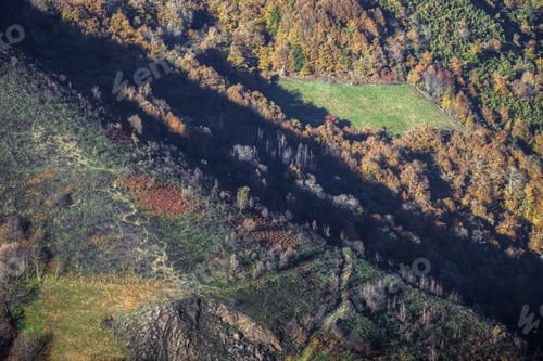 Preview: Autumnal Aerial view of Mountains and Valleys covered with Fores