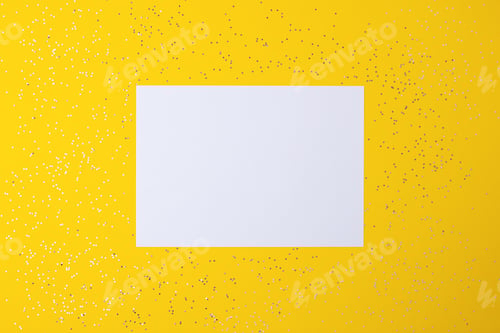 Preview: Christmas yellow minimal background with mock up greetings card and confetti. Flat lay, copy space