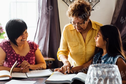Preview: Mother and grandmother helping girl with homework