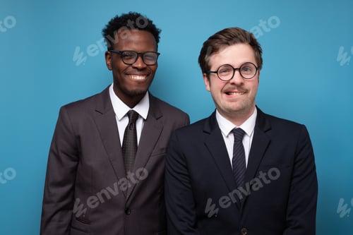 Preview: Young men in casual clothes posing with folded arms and smiling to the camera.
