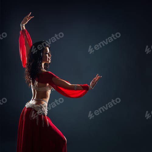 Preview: beautiful black-haired girl in red ethnic dress dancing oriental dances in the dark