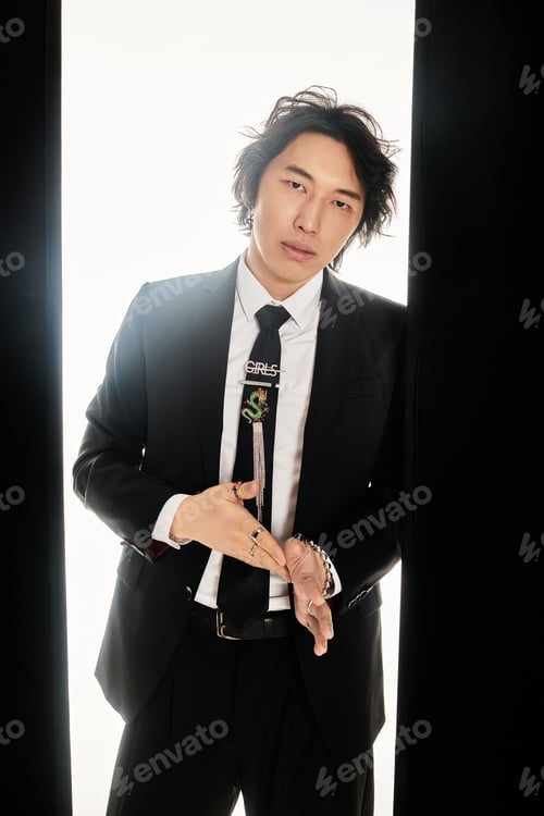 Preview: Young asian man showcasing modern fashion with stylish pose in contemporary urban setting