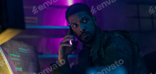 Preview: Man Using Computer Technology In A Dark Room