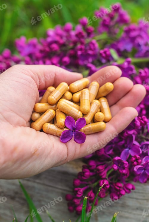 Preview: Lilac flowers extract and dietary supplements. Selective focus.