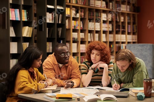 Preview: Multiethnic Young People Analyzing Study Materials Together in Library Setting