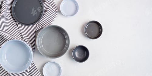 Preview: Banner with ceramic plates over light grey concrete background. Home cooking concept. Copy space
