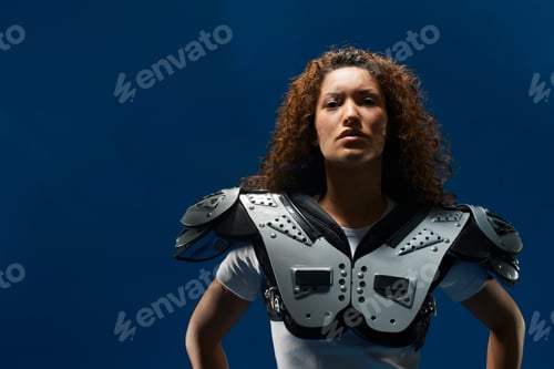Preview: Portrait of female american footballer wearing shoulder pads