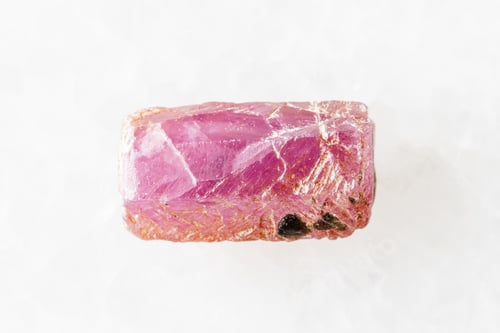 Preview: sample of rough pink ruby crystal on white marble