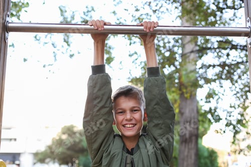 Preview: Handsome teenager doing exercises outdoors