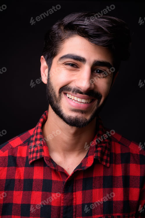 Preview: Young handsome bearded Persian man against black background