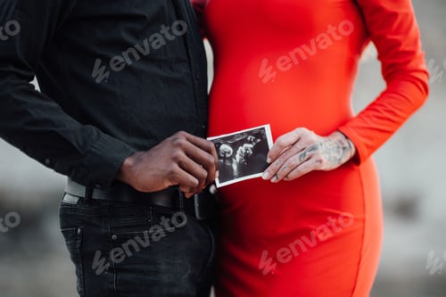 Preview: Young beautiful interracial millennial couple expecting a baby.