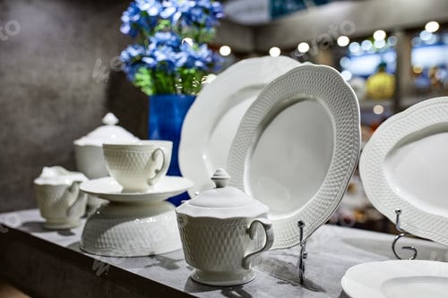Preview: a showcase with the laying of porcelain dishes. Beautiful merchandising, dishes for restaurants and
