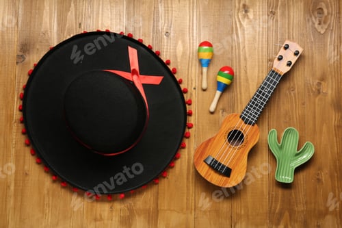 Preview: Mexican sombrero hat, maracas, toy cactus and guitar on wooden background, flat lay