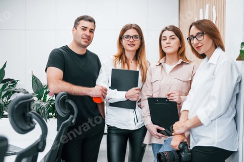 Preview: Group of business people in formal clothes standing indoors in the office together