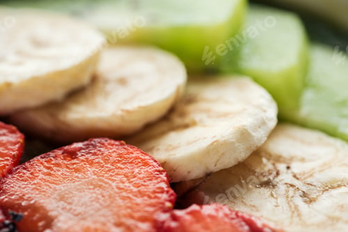 Preview: selective focus of sliced organic bananas and strawberries