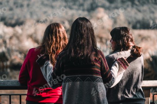 Preview: three caucasian girls two brunettes and one blonde one in a red sweater the other in a gray sweater