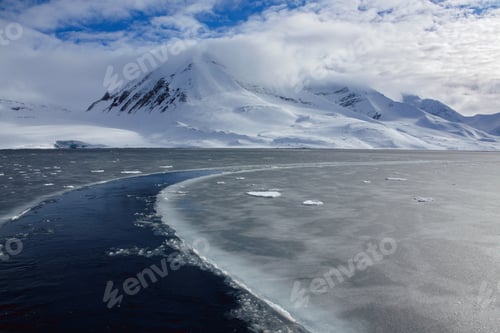 Preview: Icy landscape and a snowy mountain in the background at Svalbard, Norway