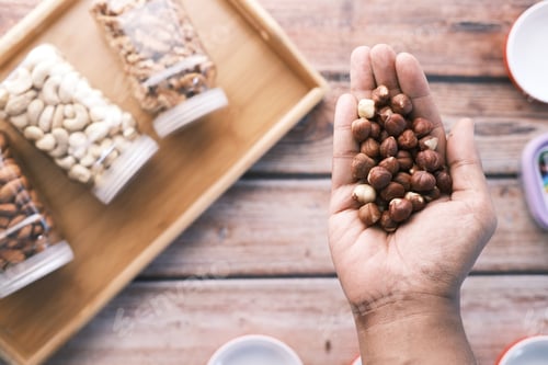 Preview: top view of hazelnuts on palm of hand