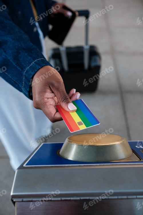 Preview: Tourist using rainbow credit card at subway station turnstile