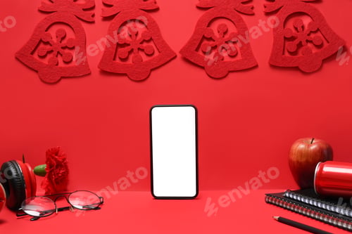 Preview: Smart phone with Christmas decorations on red background. Christmas and New year concept.