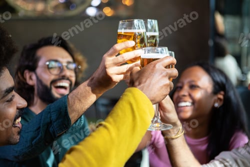 Preview: Young group of multiracial people toasting cold beer at happy hours brewery bar