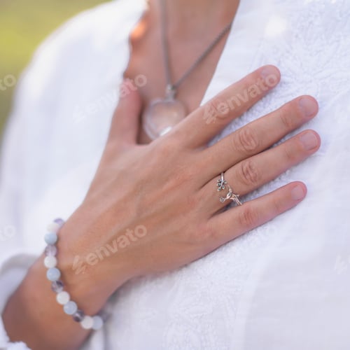 Preview: Hand With Jewelry and White Blouse Outdoors
