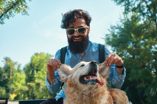 Preview: Man and dog having fun, playing, making funny faces while restin