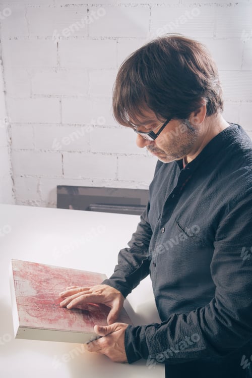 Preview: Painter artist reviewing his finished modern artwork