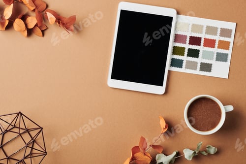 Preview: Top view of workplace of designer with tablet, color swatches and leaves