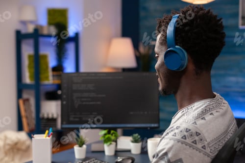 Preview: African american programmer with headset programming website code