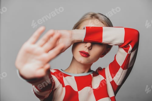 Preview: Beautiful woman with blond hair in in a 70s red square dress