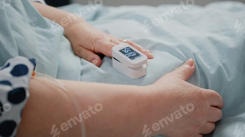 Preview: Close up of oximeter on finger showing low oxygen saturation
