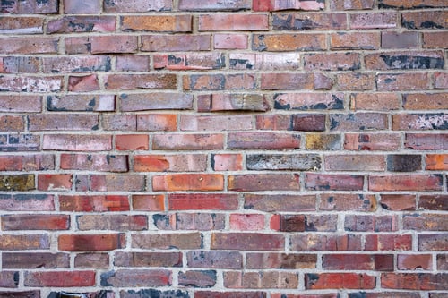 Preview: Old uneven, shabby brick wall, outdoors. Copy space. Abstract background.