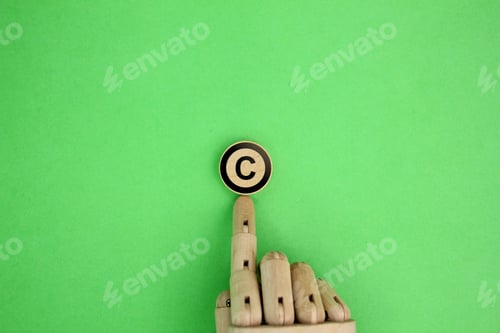 Preview: wooden hand and letter C. copyright concept.