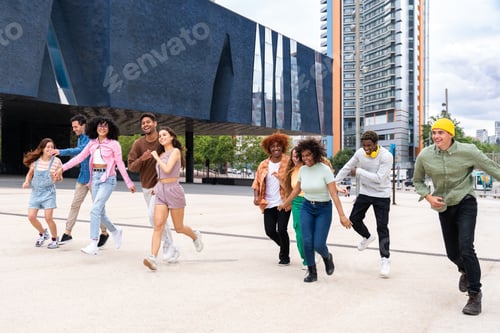 Preview: Happy playful multiethnic group of young friends bonding outdoors