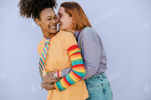 Preview: Happy multiethnic lesbian couple hugging and laughing