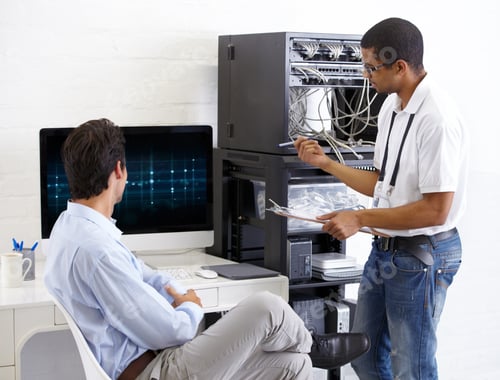 Preview: Onsite IT support. A young IT specialist ready to fix a server.