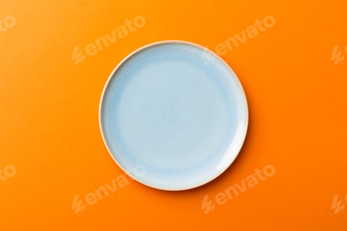 Preview: Top view of isolated of colored background empty round blue plate for food. Empty dish with space