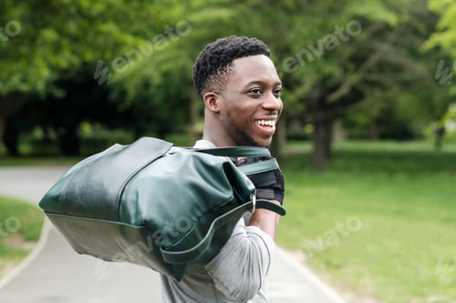 Preview: Fit young black man going to training with gym bag.