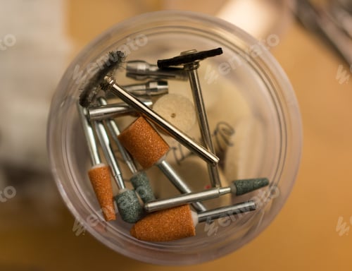Preview: Top view of different particles of an electric drill on a round surface