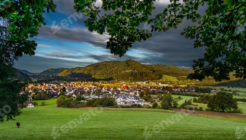 Preview: Picturesque village nestled in lush hills.