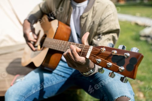 Preview: Playing acoustic guitar outdoors